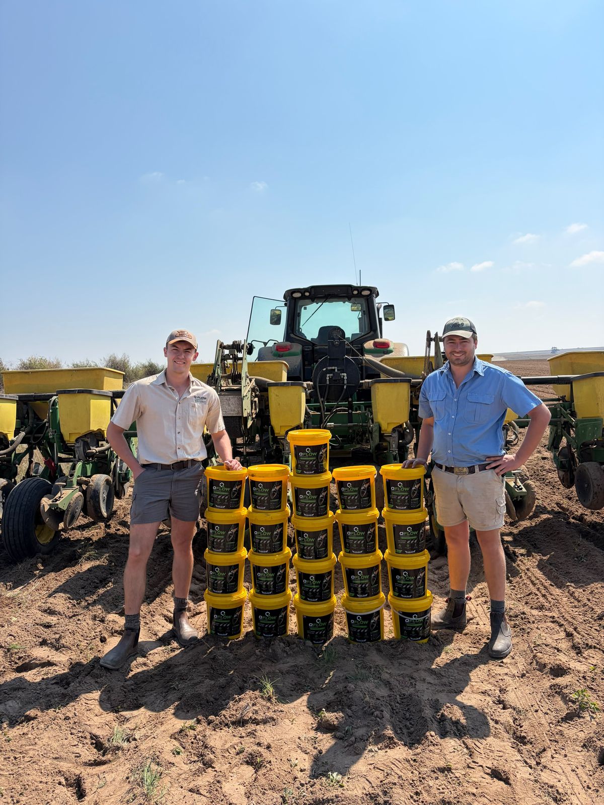 The ADLER team with stacked Q-FLOW buckets in front of a planter