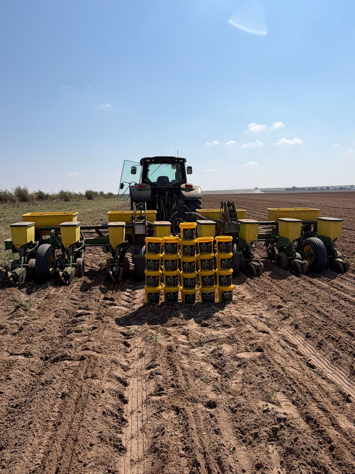Q-FLOW buckets stacked in front of a planter